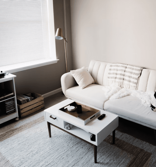 Modern living room furniture: white couch and coffee table.